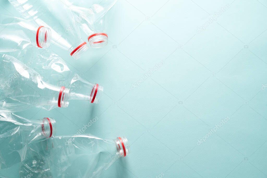 Empty crumpled plastic bottles at blue background