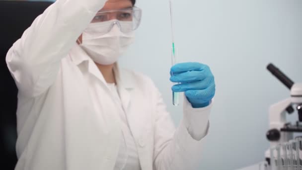 Ženský doktor analyzuje tekutinu ve zkumavce. Věda, biotechnologie, zdravotnictví a chemie koncepce. — Stock video