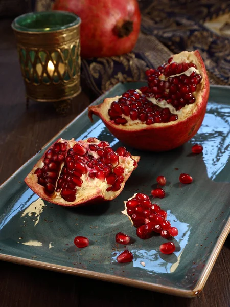 Ripe pomegranate  lies on a dish — Stock Photo, Image