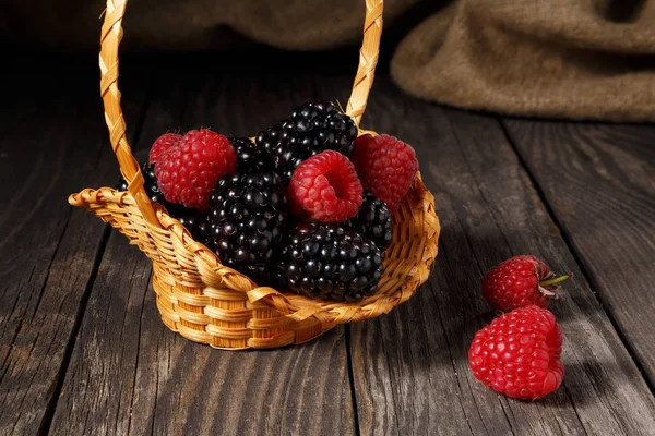 Raspberries and blackberry in a small basket — Stock Photo, Image