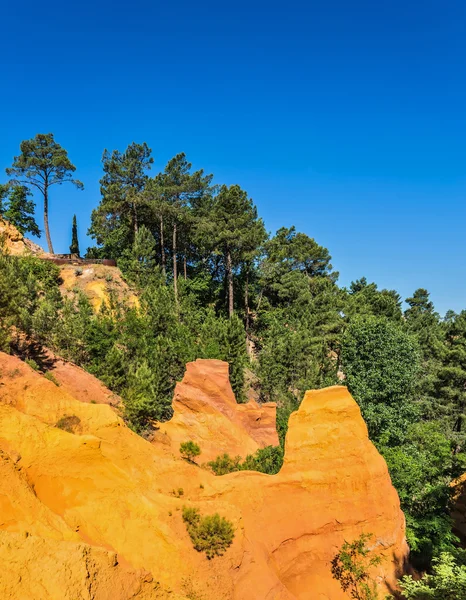 Green trees with red and orange hills — Stock Photo, Image