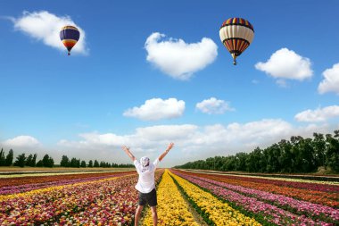 tourist looking at multi-colored air balloons clipart