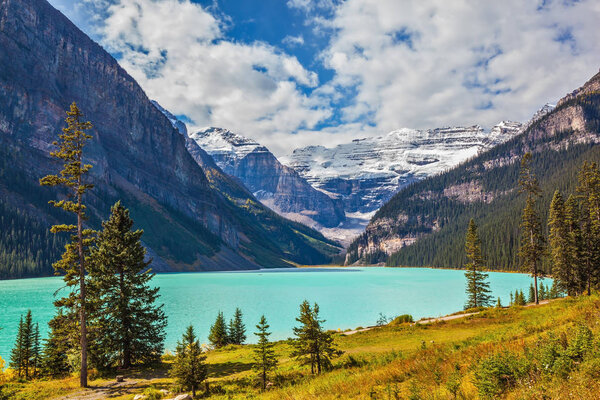 lake surrounded by mountain peaks and glaciers 
