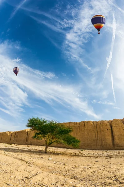 Air balloons flying over desert — Stock Photo, Image