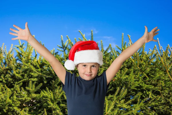 Jongen in GLB van Santa voor dennen — Stockfoto