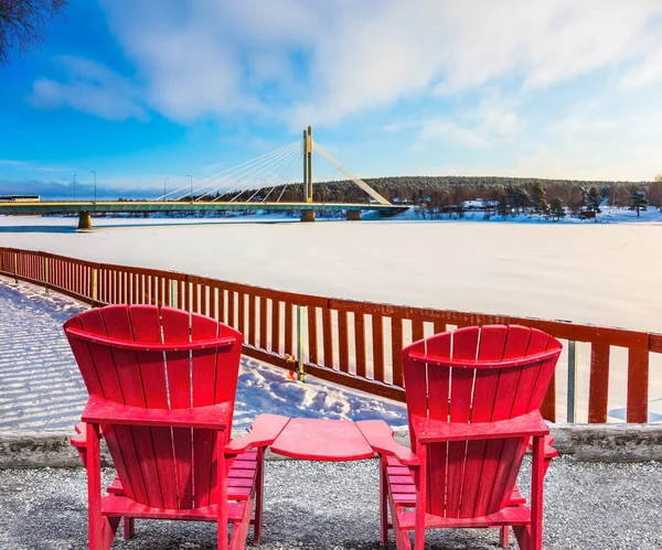 桥和冰冻的河流 北极圈 一对红色舒适的扶手椅休息 积极冬季旅游的概念 — 图库照片