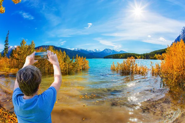 Autumn flood of Abraham lake. Artificial Abraham lake reflects the golden foliage of aspen and birches. Concept of active, ecological and photo tourism