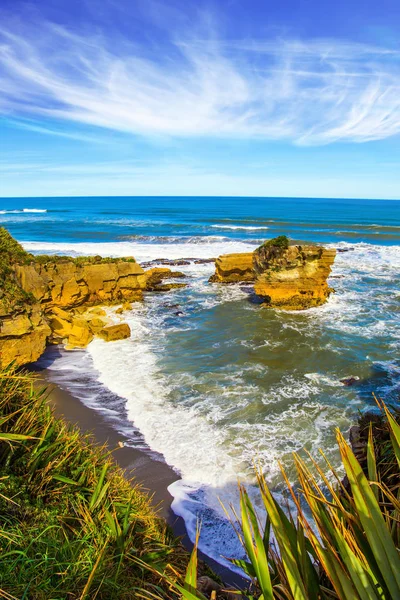 South Island, New Zealand. Pancake Rock is a natural wonder of Paparoa National Park. Scenic coastline, powerful surf, huge stones and rocks. The concept of ecological, active and phototourism