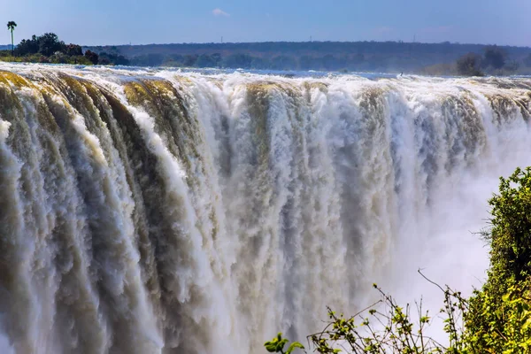 Victoria National Park, the Zambezi River. Journey after the wet season. Grand and deep Victoria Falls after the rainy season. Concept of extreme and photo tourism