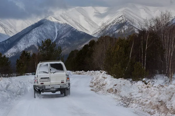 Bilen går på snötäckta vägen i Trans-Bajkal National Park. — Stockfoto