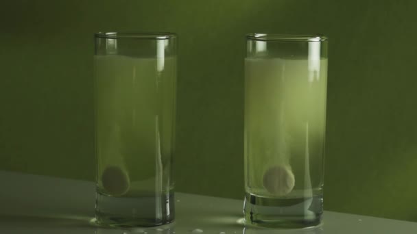 Tablet dissolves in glass of water slow motion stock footage video — Stock Video