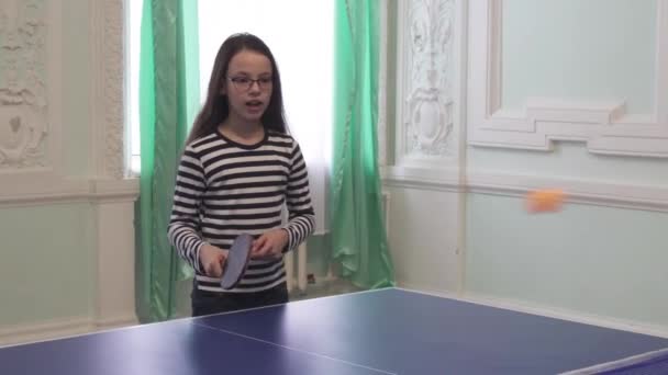 Beautiful young girl plays table tennis stock footage video — Stock Video