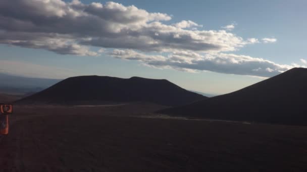 Raios de sol brilhar na câmera ao longo da estrada em antigos campos de lava em encostas de vulcões Tolbachik imagens de vídeo — Vídeo de Stock