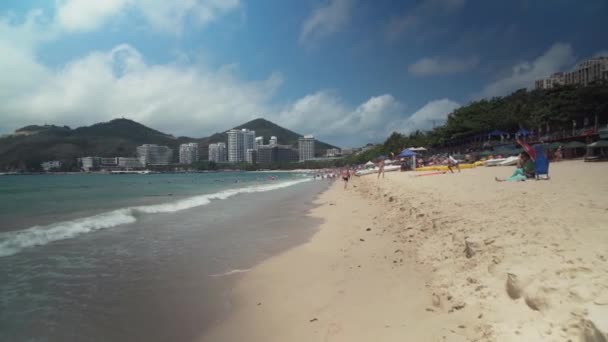 Crowded beach of Dadonghai on the tourist island of Hainan on a hot spring day stock footage video — Stock Video