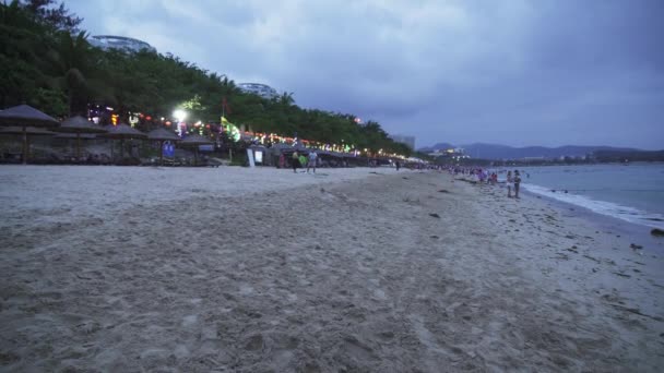 Мусор в песке после вечернего прилива на пляже Дадонгай на туристическом острове Хайнань — стоковое видео