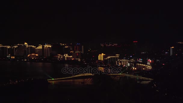 Illuminazione notturna del ponte sull'arcipelago artificiale Phoenix Island vista dal video stock del Luhuitou Park — Video Stock