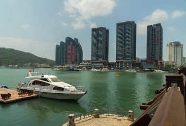 Modern skyscrapers on the embankment of the Sanya River in Sanya City on Hainan Island clipart