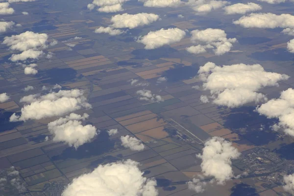 Cumulus clouds over the fields from airplane view — Stock Photo, Image