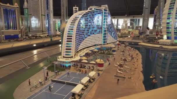Exhibition of mock-ups Jumeirah Beach Hotel and Burj Al Arab Hotel made of Lego pieces in Miniland Legoland at Dubai Parks and Resorts stock footage video — Stock Video