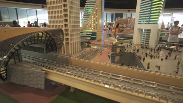 Exhibition of mock-ups Dubai subway near skyscrapers made of Lego pieces in Miniland Legoland at Dubai Parks and Resorts stock footage video — Stock Video
