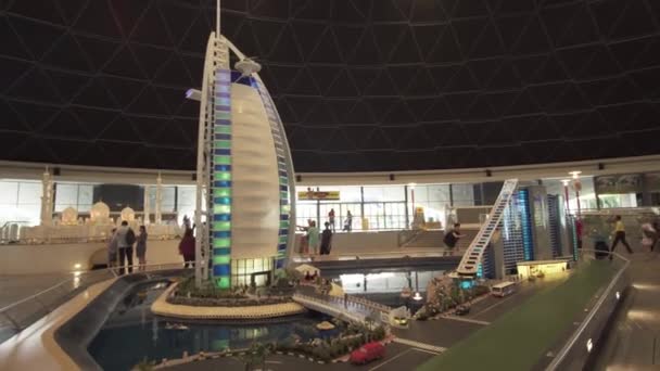 Exhibition of mock-ups Jumeirah Beach Hotel and Burj Al Arab Hotel made of Lego pieces in Miniland Legoland at Dubai Parks and Resorts stock footage video — Stock Video