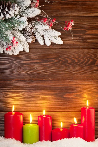 Candles in snow and fir tree branch — Φωτογραφία Αρχείου