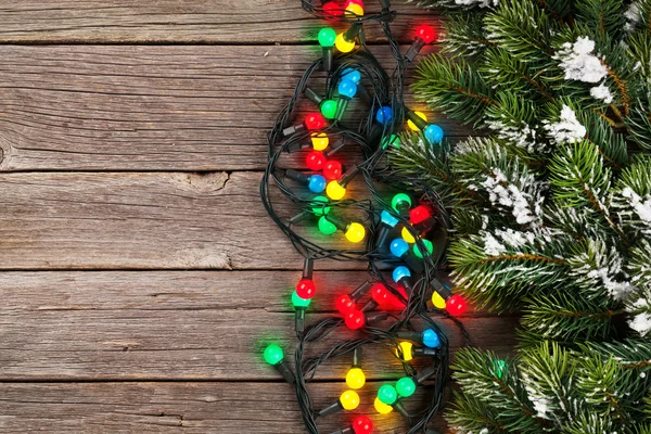 Snow fir tree and colorful lights — Stockfoto