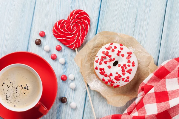 Donut with heart lollipop and coffee cup — Stock Photo, Image