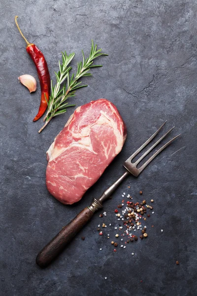 Raw beef steak with fork — Stock Photo, Image