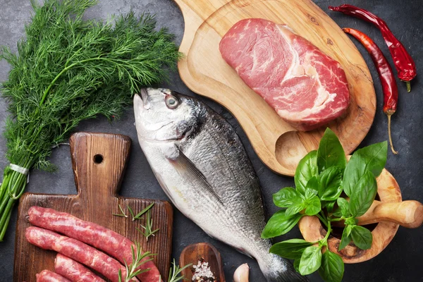 Fish between cutting boards with meat — Stock Photo, Image