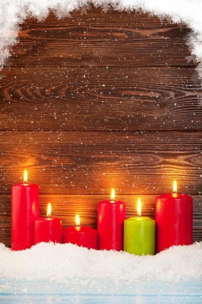 Christmas background with candles in snow — Stock Photo, Image
