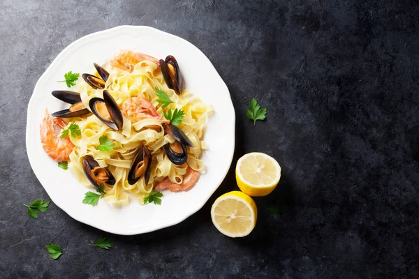 Pasta with seafood on stone table — Stock Photo, Image