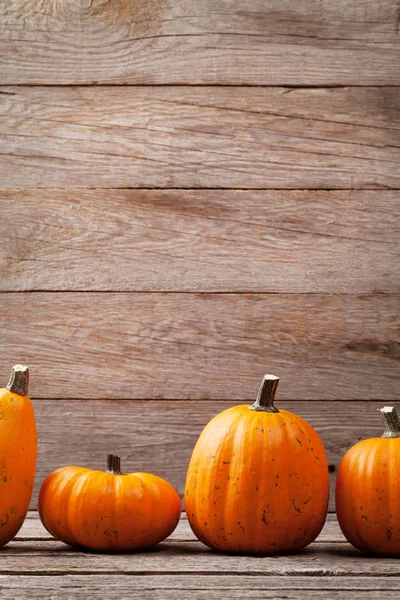 Autumn pumpkins on wooden boards — Stock Photo, Image