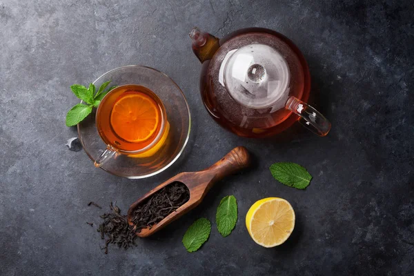 Tea cup with teapot and tea in spoon — Stock Photo, Image