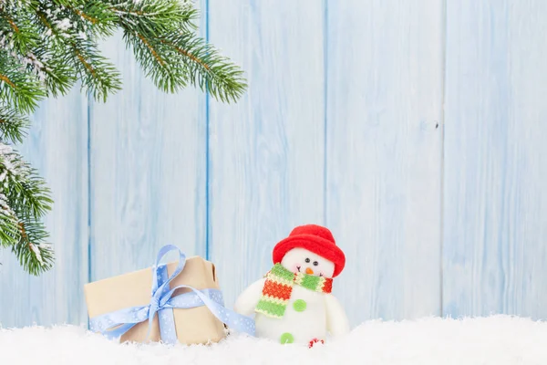 Christmas gift box and snowman toy — Stock Photo, Image