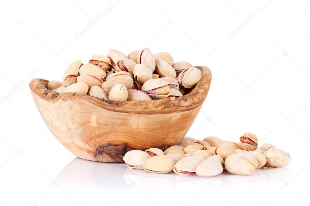 Pistachios nuts in wooden bowl