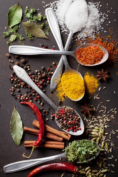 Various spices spoons on stone table — Stock Photo, Image