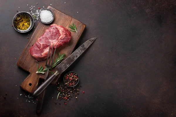 Raw ribeye beef steak cooking — Stock Photo, Image