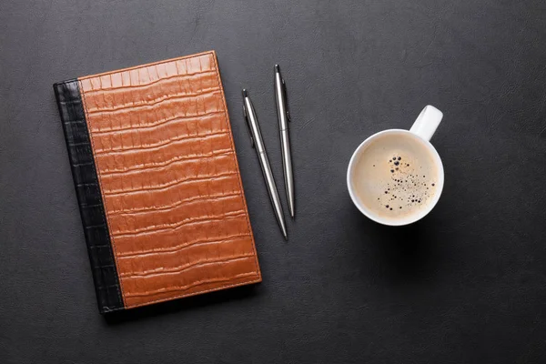 Table with notepad, coffee, pen and pencil — Stock Photo, Image