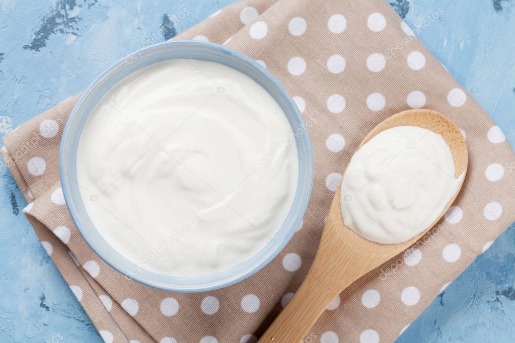 Sour cream in bowl and spoon