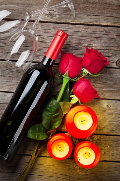Red rose flowers, wine and candles — Stock Photo, Image