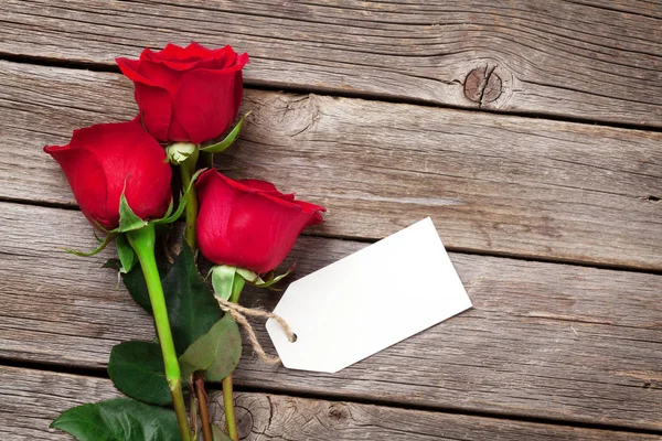 Rose flowers and blank label — Stock Photo, Image