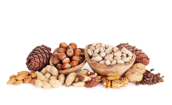 Различные орехи в деревянных чашах — стоковое фото