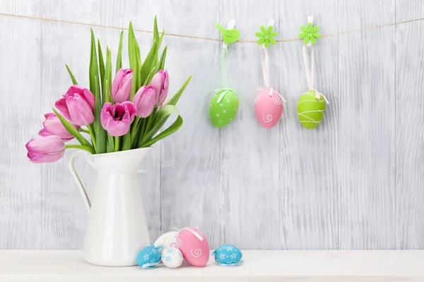 Easter eggs and pink tulips bouquet — Stock Photo, Image