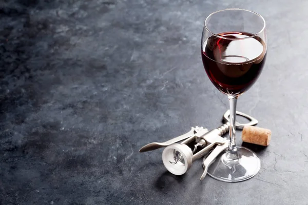 Red wine glass and corkscrew — Stock Photo, Image