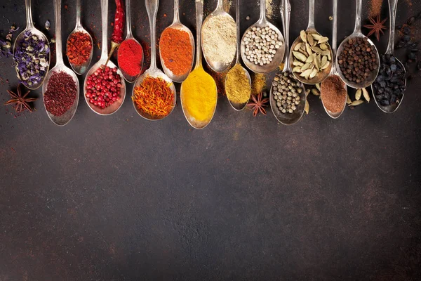 Various spices spoons on stone table. Top view — Stock Photo, Image
