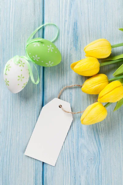 Easter eggs, tulips and blank tag — Stock Photo, Image