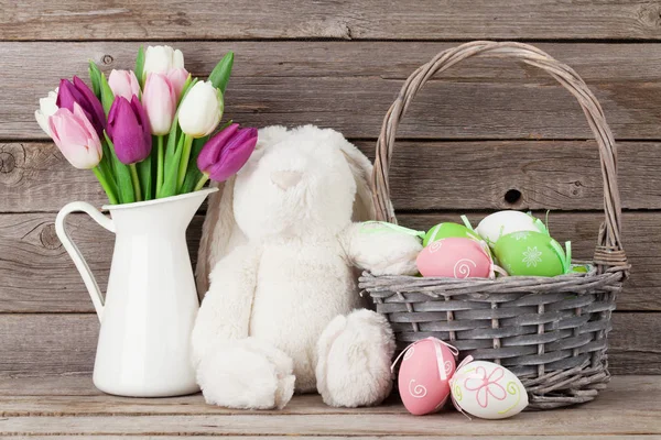 Rabbit toy, easter eggs and tulips — Stock Photo, Image