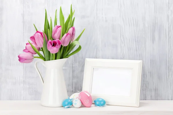 Easter eggs, photo frame and tulips — Stock Photo, Image