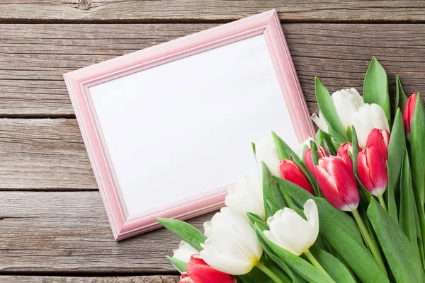 Fresh tulips and photo frame — Stock Photo, Image